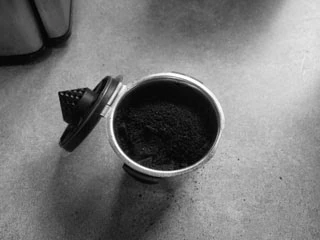 Tap the Filter to Lower  and Settle the Ground Coffee